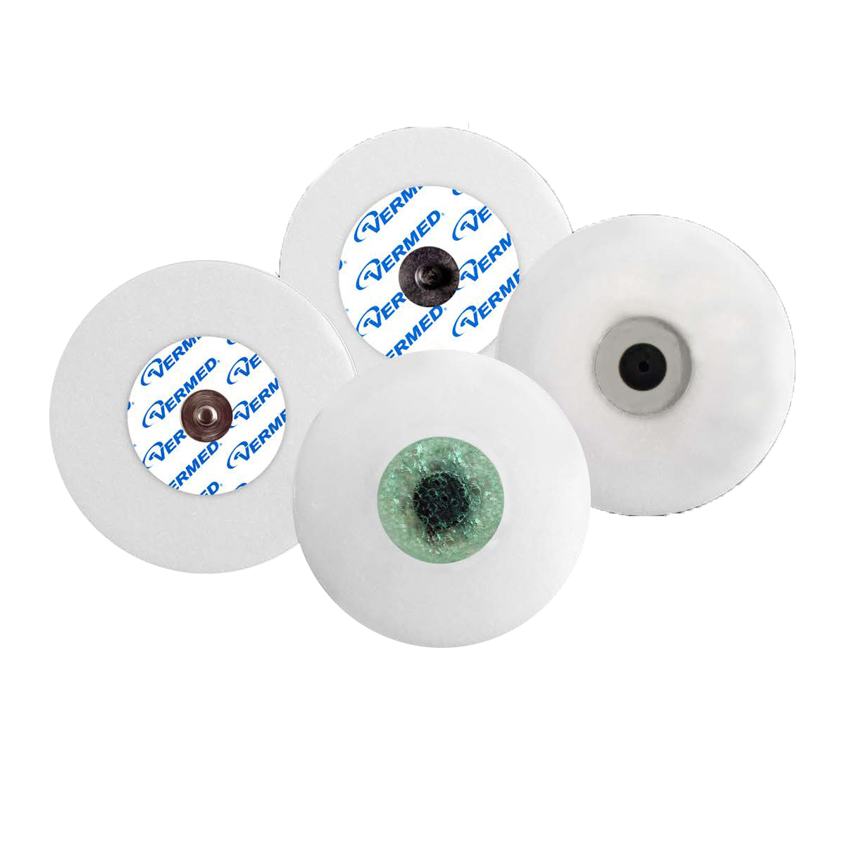 Fyra runda EKG-elektroder i vitt med olika mönster och metallkontakter i mitten.