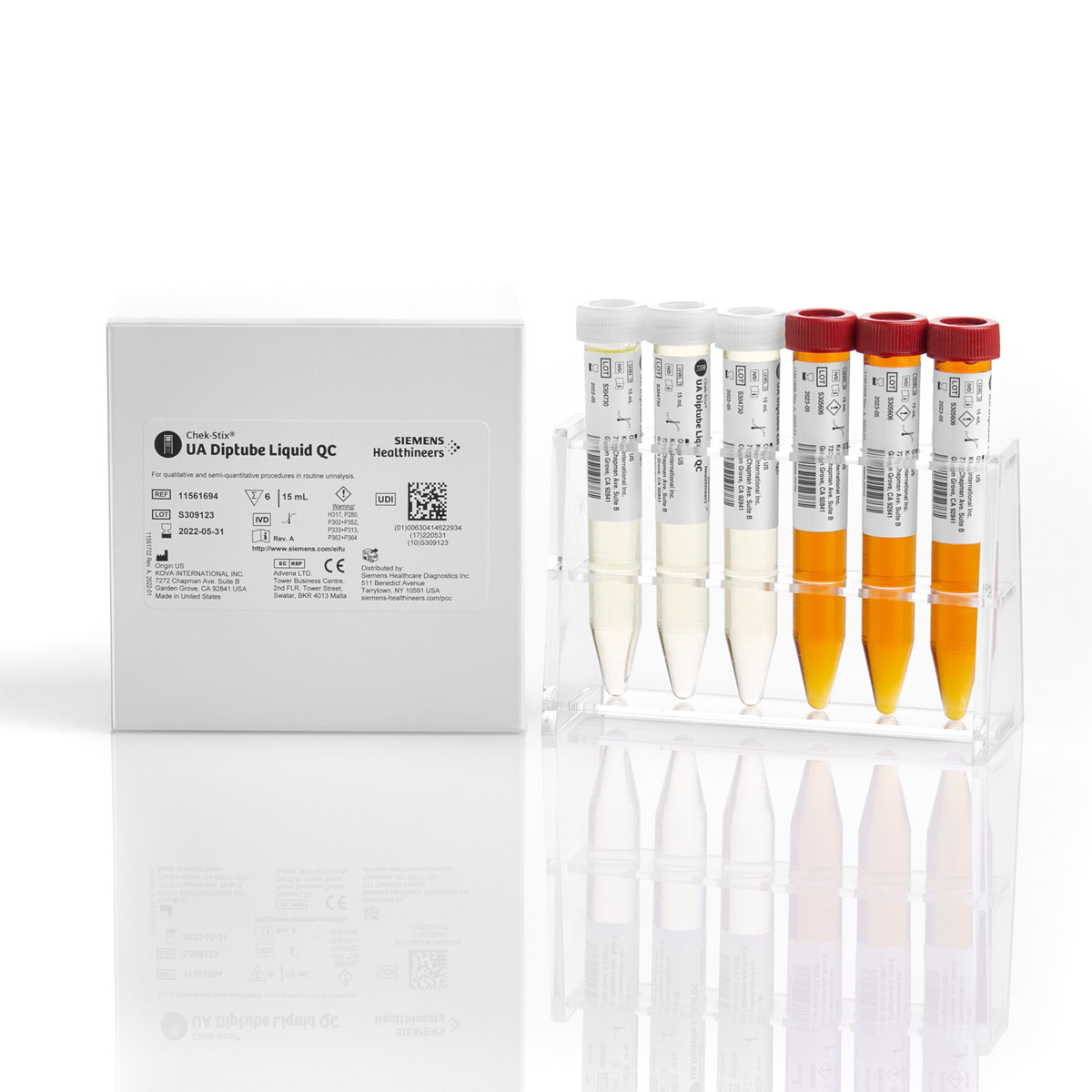 Vita och orange vätsketuber i ställ bredvid en förpackning märkt Siemens Healthineers UA Diptube Liquid QC.